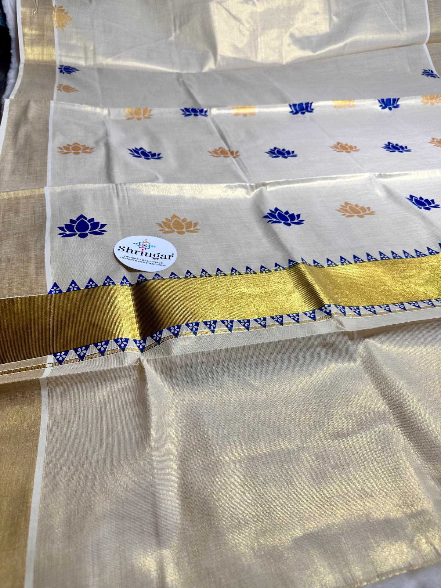 Kerala Saree with blue and gold lotus motifs