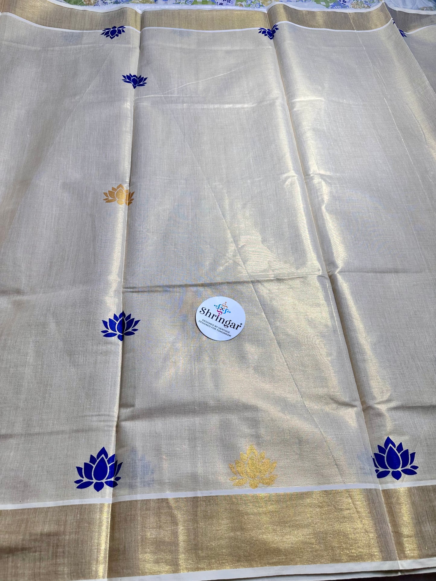 Kerala Saree with blue and gold lotus motifs